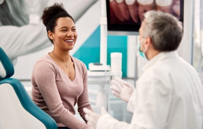 Happy patient speaking with a dentist.
